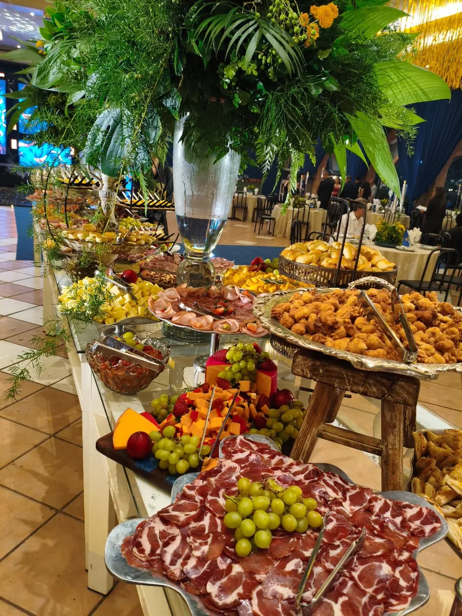 Mesa completa de frutas e finger food em um casamento
